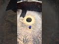 Marbles spinning round and round in a wooden kneading bowl