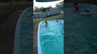 Boy jumps on boogie board in pool and sinks to the bottom then girl gets hit on face (Slow motion)
