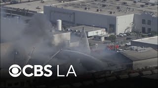 LA County firefighters extinguish flames burning Vernon warehouse