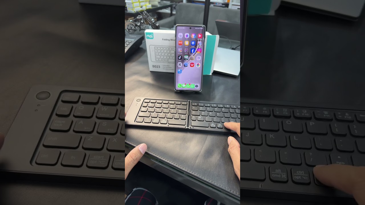 B023 Mini Foldable Bluetooth Keyboard and Mobile Phone Holder.