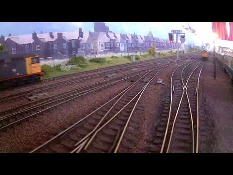 D200 passes Haymarket MPD, followed by Railfreight 26025