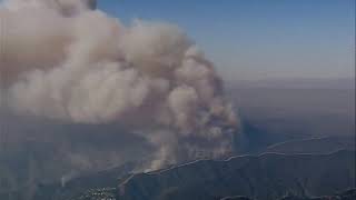 Aerial views shows thick smoke cloud over Los Angeles area as fires burn on