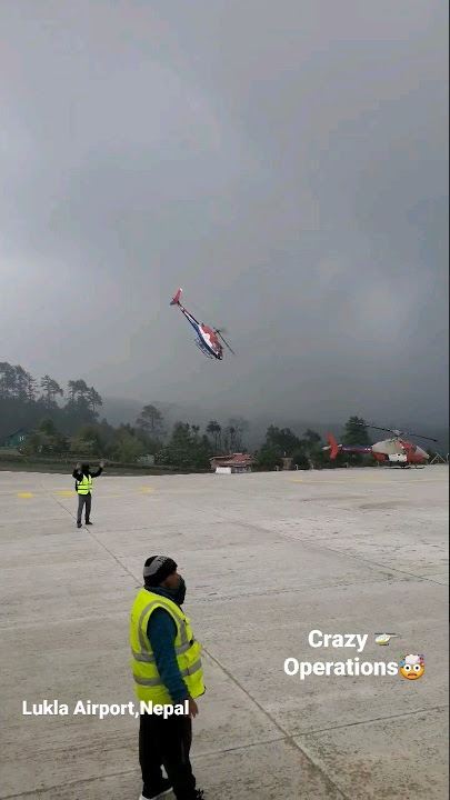 Lukla Airport, Nepal - crazy helicopter operations during bad weather.