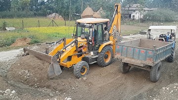 JCB Backhoe Collecting Gravel to Load in Tractor - JCB Machine Working on Crusher