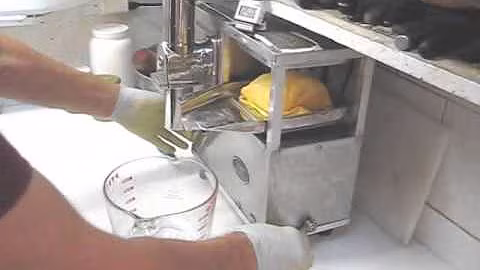A Whole Health Foundation juicer making pulp free citrus juice. A Norwalk juicer alternative.
