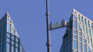 Two People Rescued After Lift Swings 'Wildly Out of Control' at Top of Tower, Fire Officials Say