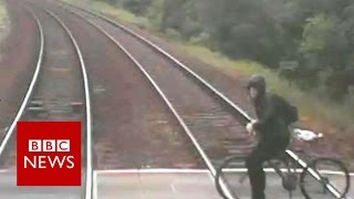 Cyclist's near-miss with train released - BBC News