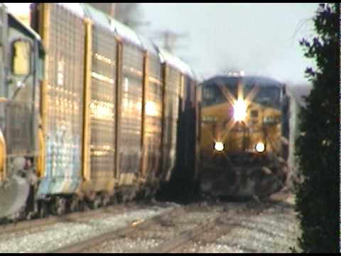 Freight train passes a stopped auto rack at Jessup Station, MD. The auto rack pulls ahead in another video.