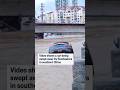 Video shows a car being swept away by floodwaters in southern China