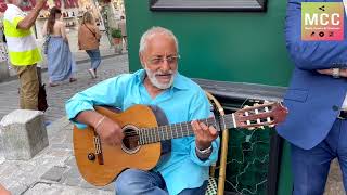 He takes up improvised guitar-voice The Sound Of Silence on the terrace of a Parisian café