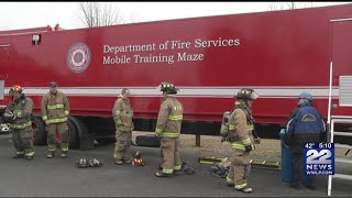 Firefighters train using a maze trailer