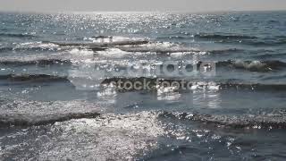 Slow motion sunlit waves coming into shore stock video. PEC, Lake Ontario, Canada. HD video.