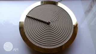 Studio Ayaskan designs clock that rakes sand to illustrate the ripples of time