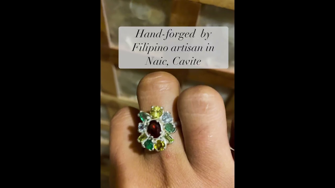 Red garnet ring with zircons, peridots, emeralds and heliodor