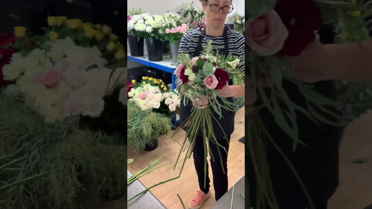 A stunning cascade wedding bouquet in burgundy, dusky pink and ivory 