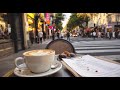 POV sitting at a street café watching people walk by