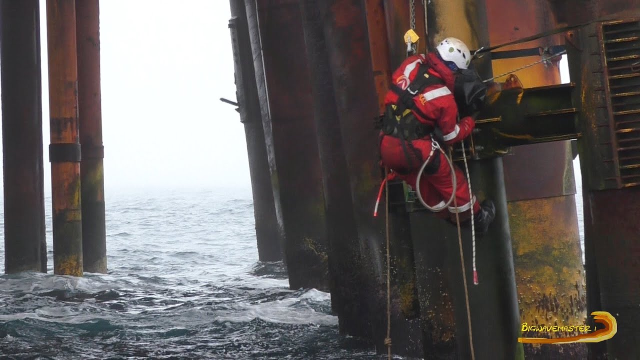 North Sea Abseilers working just above the ocean on an oil rig. A view that very few get to see.