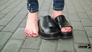 Black Flip Flops On Bare Feet