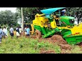 John Deere 5075E harvester stuck in mud and pulling out by JCB.