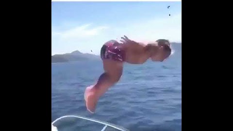 Midget jumping into the water