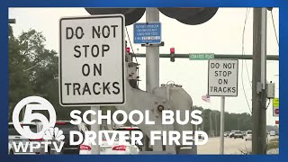 Bus driver fired after stopping bus full of students on train tracks as freight train approaches