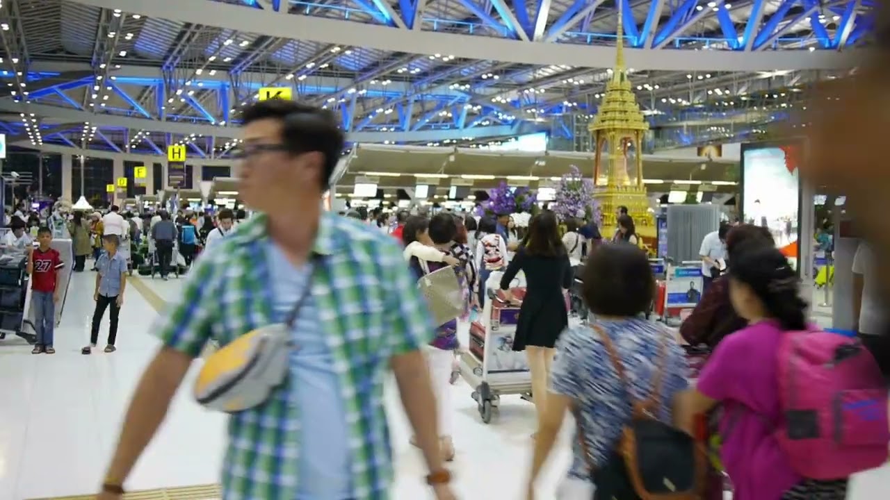 VideoVault Stock Video: People walking through an airport in Thailand
