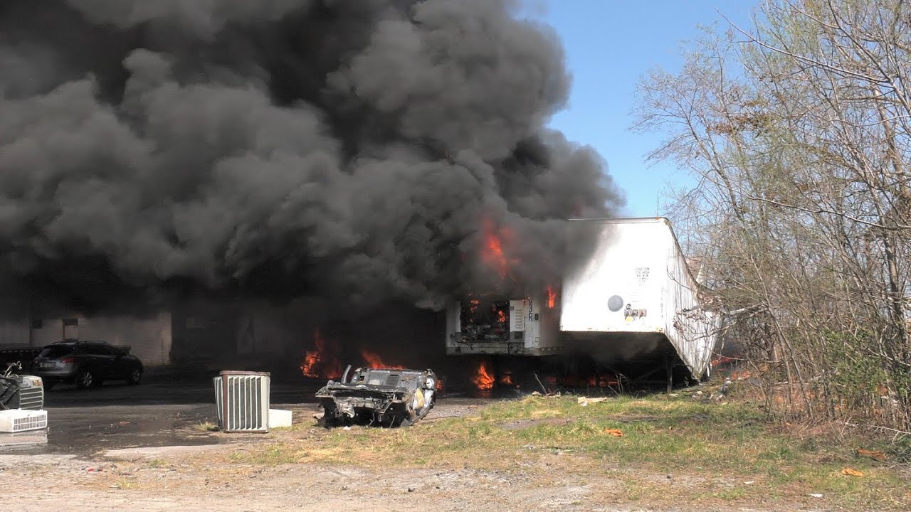 Firefighters battle multiple trailers burning at industrial complex