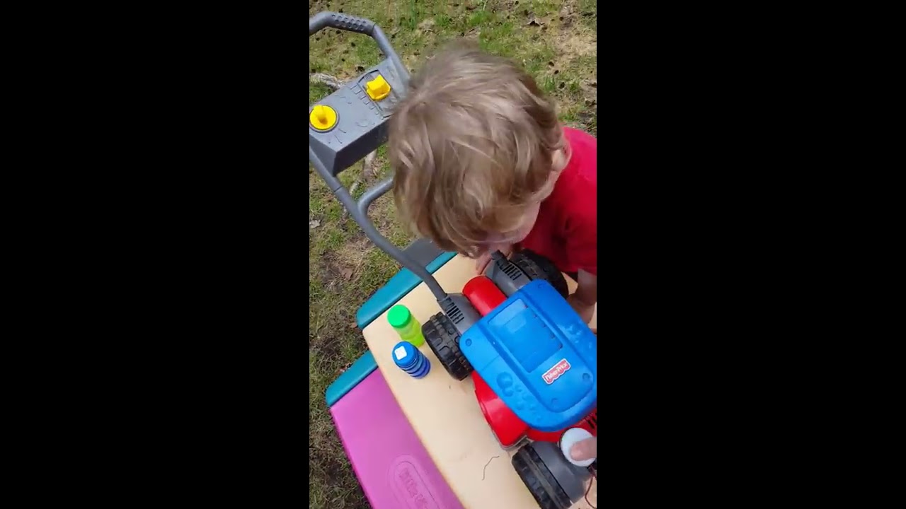 Filling up the bubble mower and mowing the grass,Aden and Ethan toy reviews and fun videos