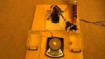 Computer controlled digital scale - robotic arm automation. Part separation by weight.