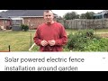 Solar powered electric fence installation around garden