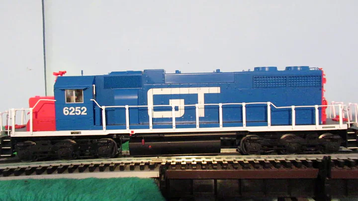 Grand Trunk Western O scale freight train gradually rolls down the tracks.