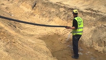 Flooding the Pipes Trench with Water for Compaction Works