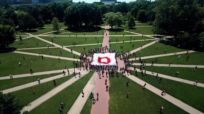 People coming together on campus with the OSU banner.