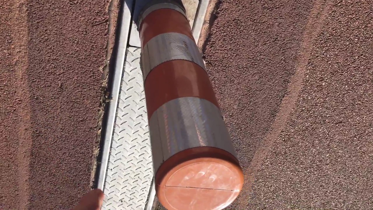 Heavy plastic bollard which allows maintenance and emergency access
