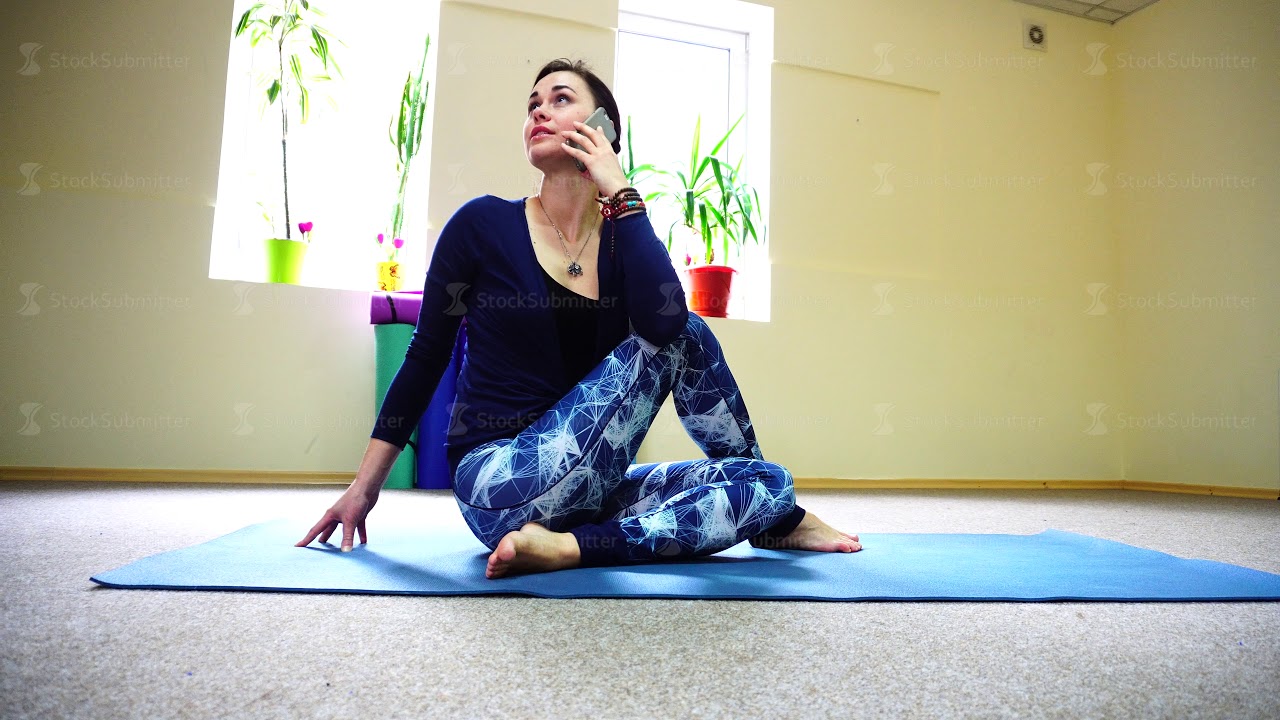 Wedding planner talking on phone during Pilates class