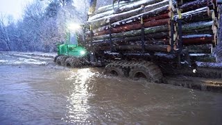 John Deere 1110E with big load in wet, snowy, beautiful winter forest