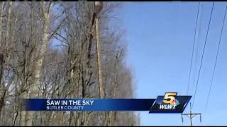 Power company uses giant saw dangling from helicopter to trim trees
