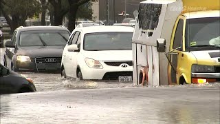 Cars navigate flooded Houston roads
