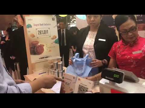 Customer uses SGQR to pay for items newspaper mockup