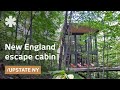 Modern cabin hangs like a treehouse over Acadian New England