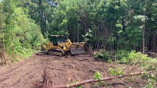 Cat 963 clearing old farm field full of drip tube and plastic.