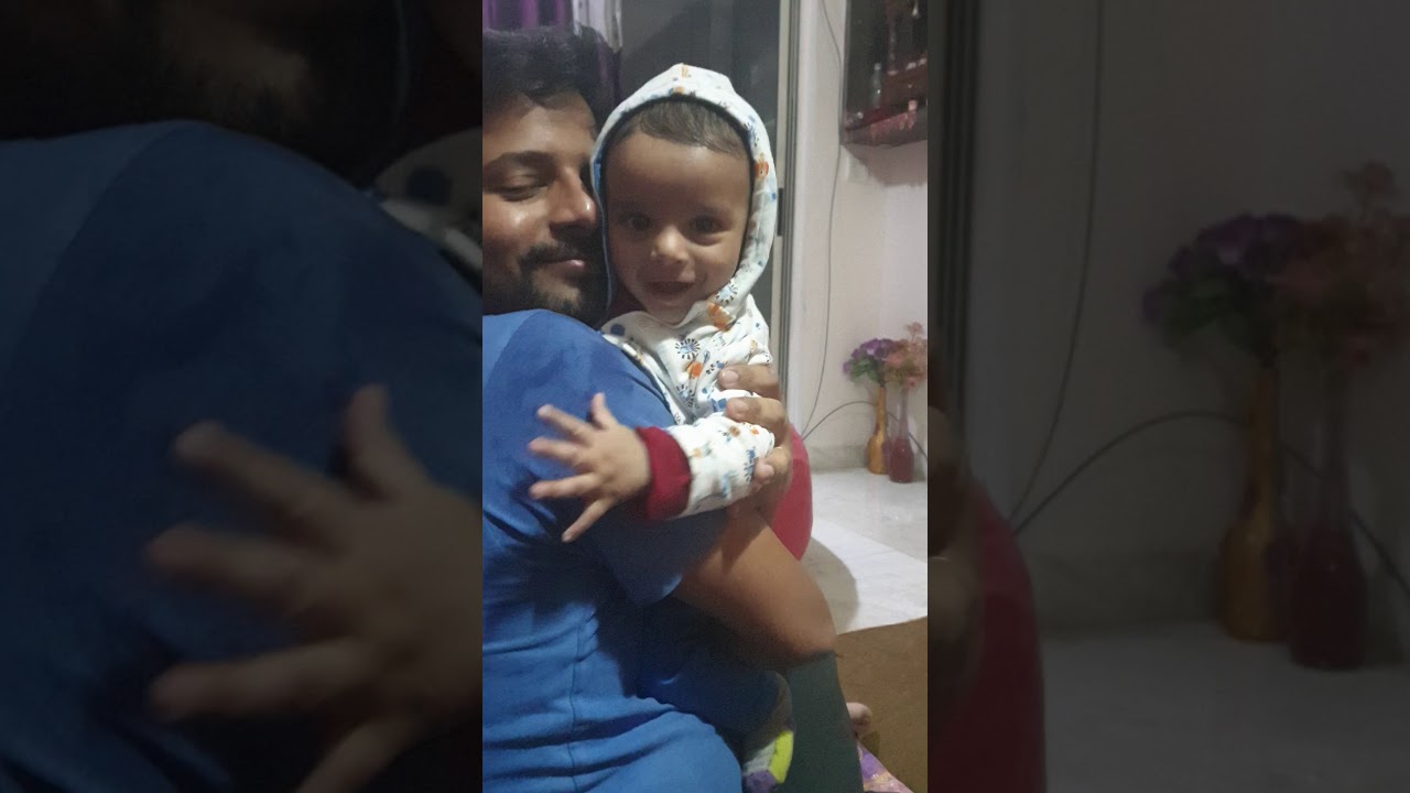 Baby smiling in daddy's lap