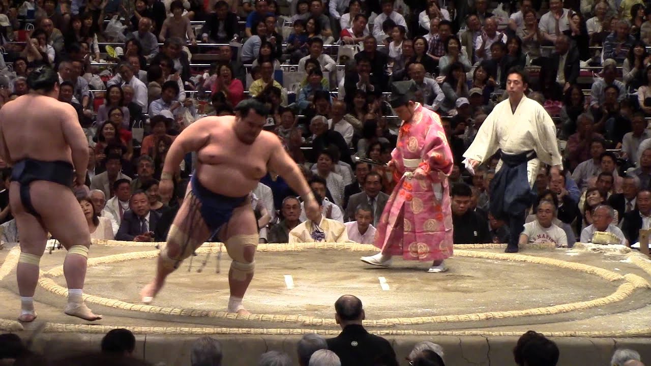 Sumo wrestlers throw a handful of salt to purify the Dohyo ring. YouTube