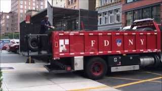 RARE CATCH OF FDNY TIRE TRUCK CHANGING TIRE ON FDNY ENGINE 5 IN CAGE OUTSIDE FDNY ENGINE 33 HOUSE.