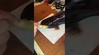 Beeswaxing parade shoe ready for bulling