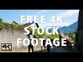 Free 4K Stock Footage - People Walking Up Village Path - Mountain Backdrop