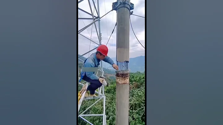Worker breaking concrete electric pole