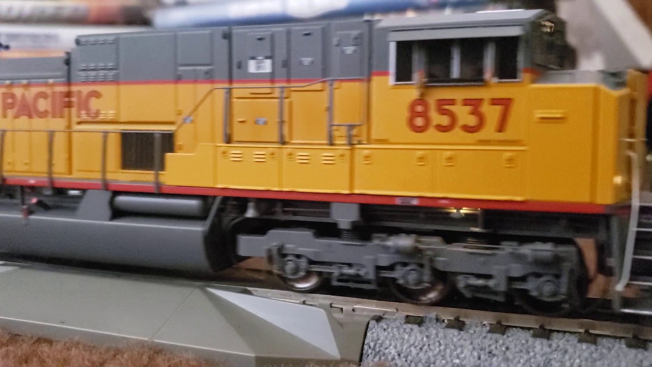 Athearn Genesis Union Pacific SD90MAC-H with a HO Scale Baretable train...