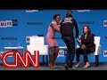 Protester grabs Kamala Harris' microphone on stage