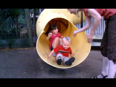 Toren going down the slide at the zoo - with little girl